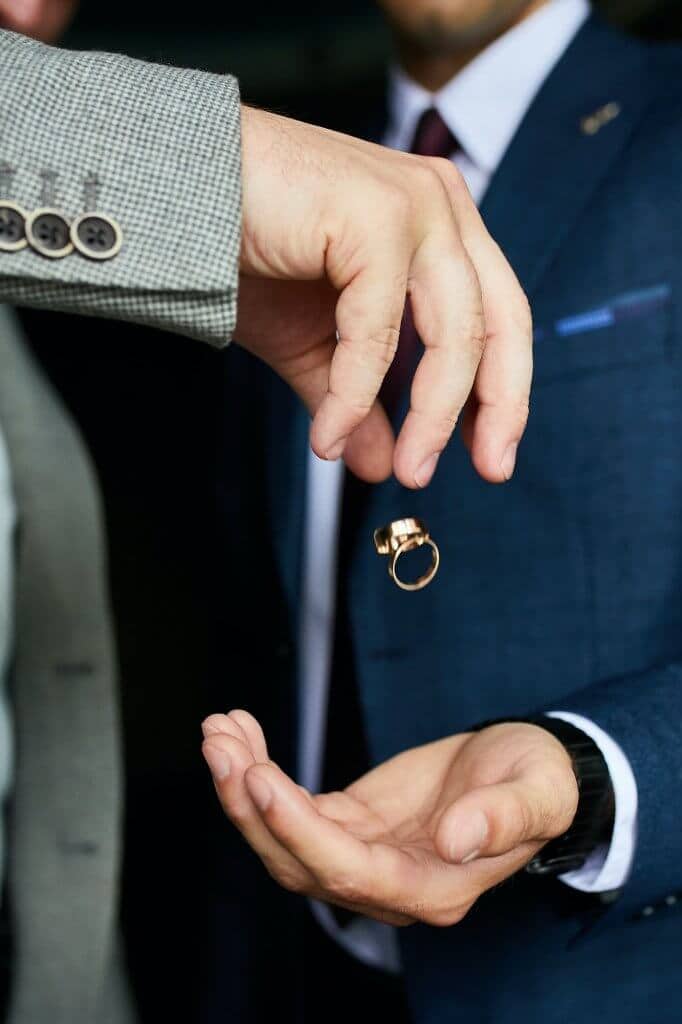 Wedding rings, levitation items. The groom holds the rings.