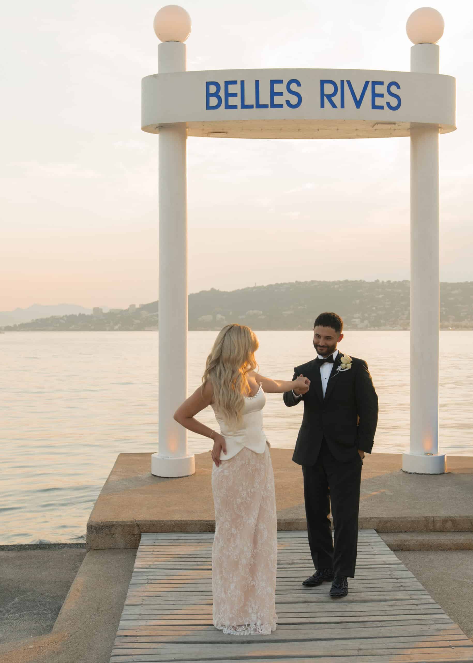 Madina and Ali beside the water near the Belles Rives sign.