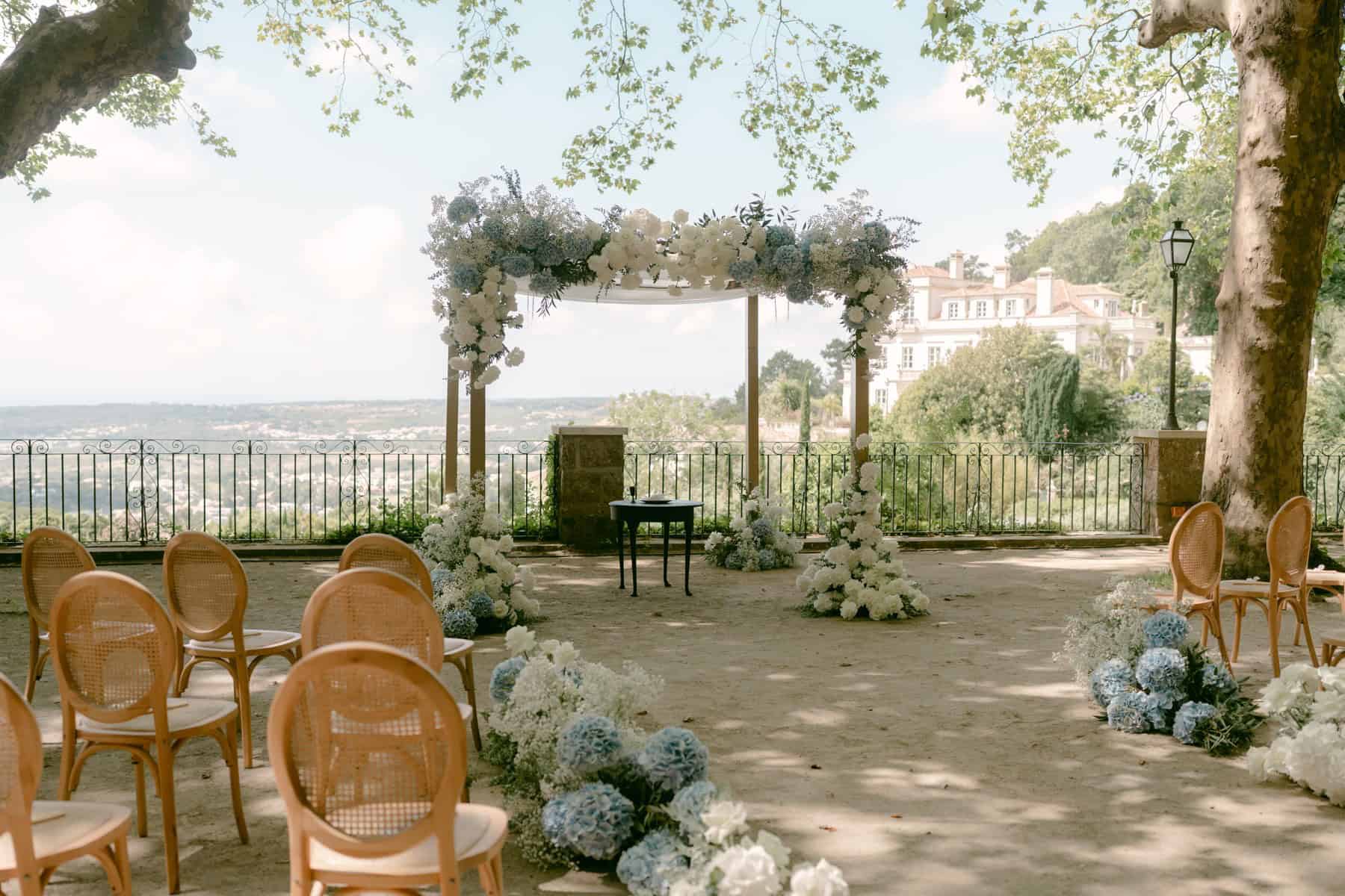 Outdoor wedding ceremony setting with a floral chuppah at Quinta da Bella Vista in Sintra.